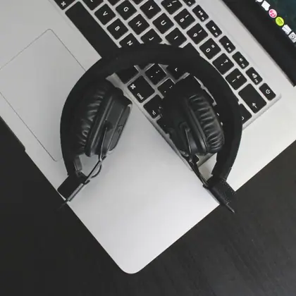 Headphones resting on a laptop keyboard